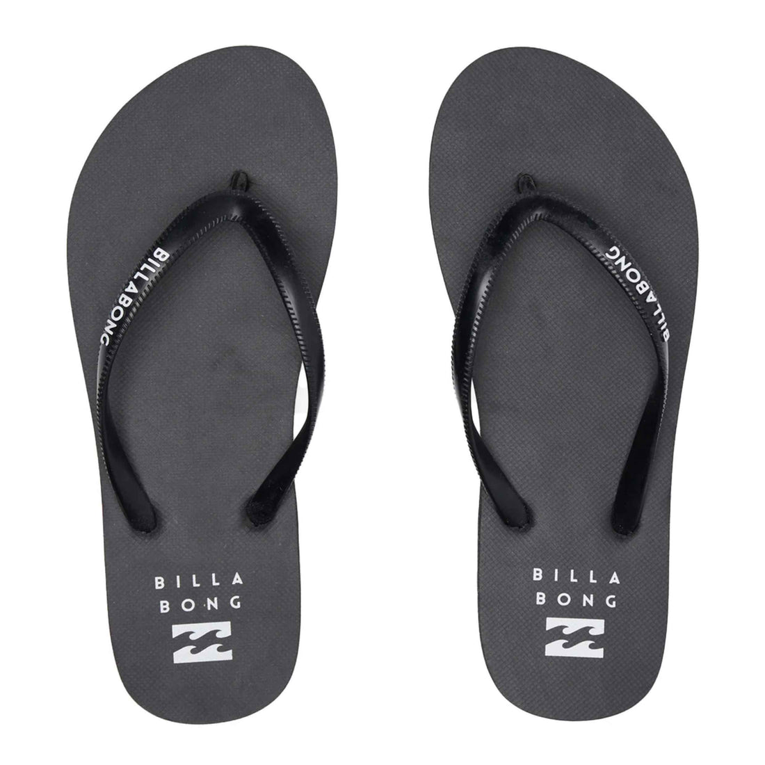 A pair of Billabong flip-flops in dark gray with black straps, featuring white brand lettering and logo on the footbeds, set against a plain white background.