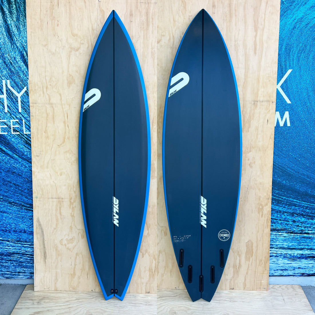 The Dylan Shapes Lucas Chumbo Pro 6'11 Dark Blue Blue Rail Spray Surfboard — a high-performance big-wave board designed with Lucas “Chumbo” Chianca, built for unmatched paddle power, hold, and precision in serious surf.

The proven Chumbo has a flat deck that distributes volume to the rails, low rail profile for enhanced control, and a deep double concave through vee. This model is engineered to deliver speed, drive, and responsiveness in heavy water.