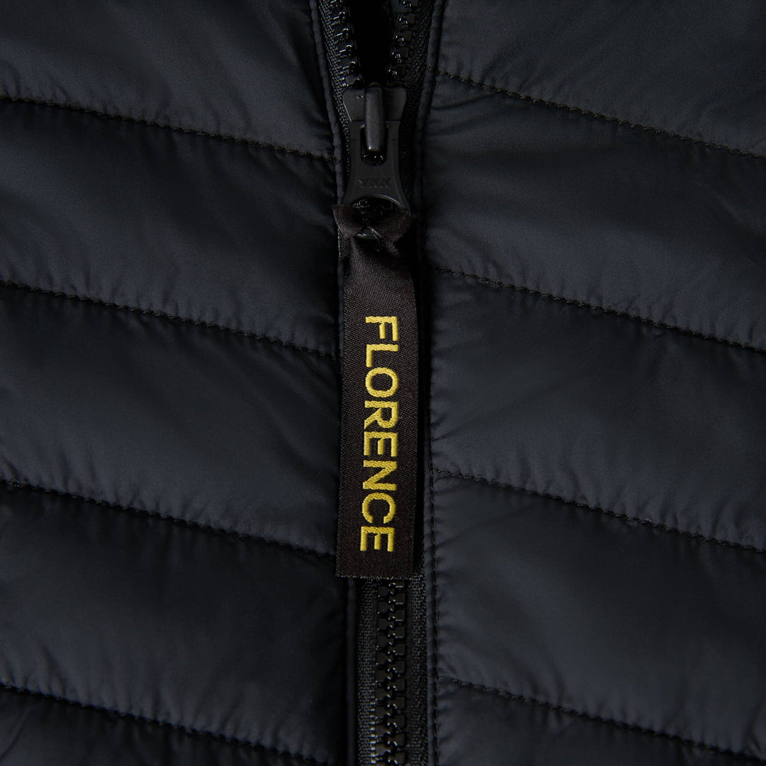 Close-up of Florence Marine X Dispatch PrimaLoft Jacket Black zipper detail with durable reverse coil design, NZ.