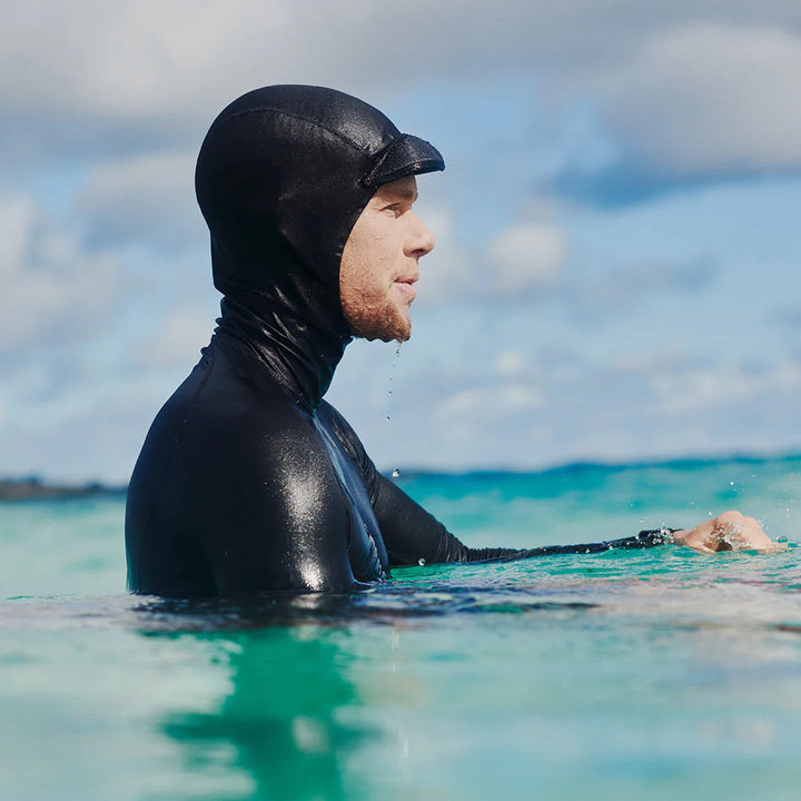 John John Florence wearing the standard issue Hooded rash guard in black surfing line up