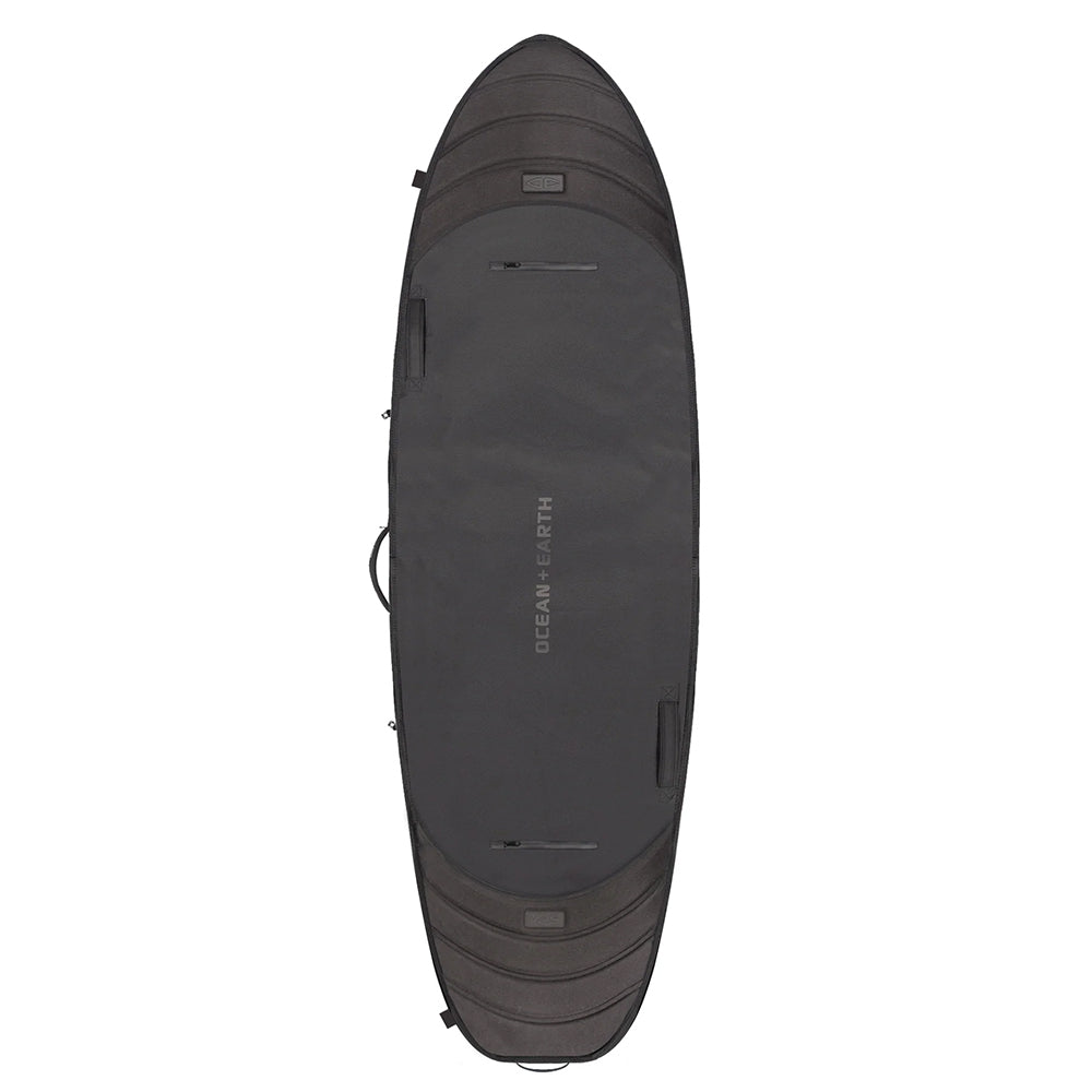 A black travel cover for surfboards designed with contoured rail gusset, anti shock shoulder strap, and external compression straps.