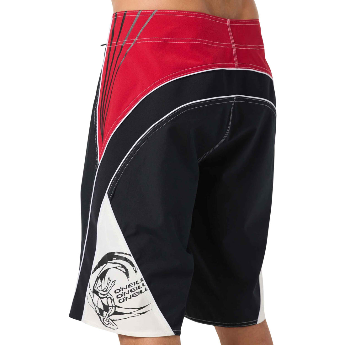 A close-up side view of a person wearing board shorts, showing the back and side panels. The shorts are black with a red upper section, white side panels, and a black and white O'neill surfer dude Design logo near the hem.