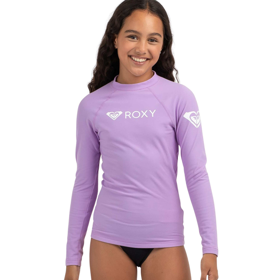 Roxy Girls Heater long sleeve lycra rash vest in Crocus Petal — fitted kids rashie made from stretchy nylon polyamide elastane fabric, available at Freeride Surf & Skate NZ.