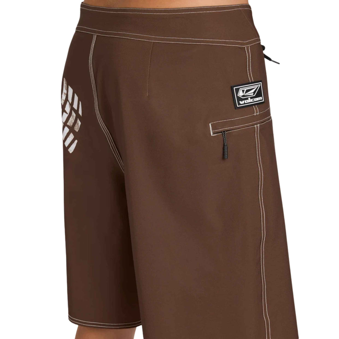 Brown board shorts with white contrast stitching, a white geometric logo on the left leg, and a black and white Quiksilver patch on the right pocket, shown on a model against a white background.