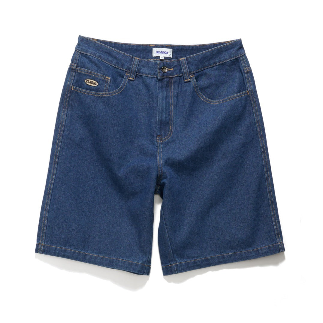 A pair of blue, washed denim shorts with a fixed waist, five pockets, and a woven label on the back pocket. The brand's classic XLARGE embroidered logo is visible on the coin pocket.