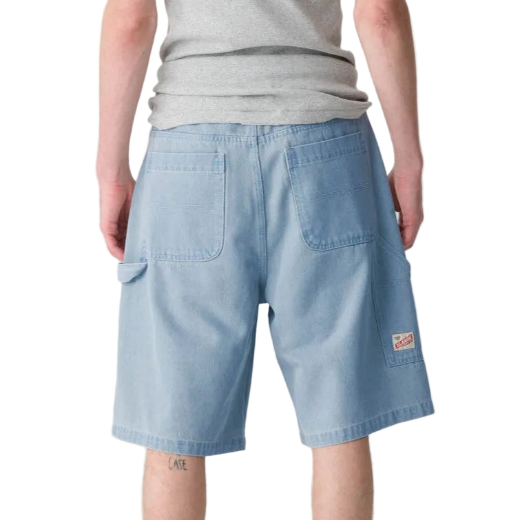 XLARGE Denim Work Short in washed Mid Blue with baggy wide-leg fit, knee panels and workwear tool pocket.